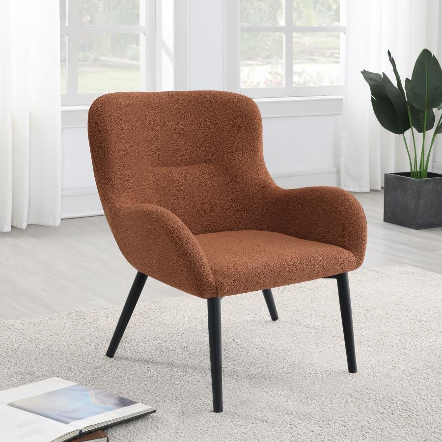 Add a touch of color to your living room seating ensemble with a modern accent armchair. Its inviting silhouette boasts prominent curves, with a rounded back and flared arms. A single line of tufting adds dimensionality to the look, while plush foam cushi