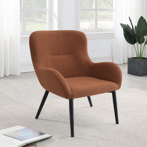  with a rounded back and flared arms. A single line of tufting adds dimensionality to the look