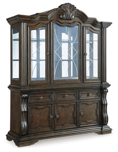 From its ornamental appliques to its large scale, this dining buffet with hutch makes a bold statement. With decorative pilasters, beveled glass windows and plenty of storage, the opulent piece wows with stunning style. The look is timeless. The feel? Rig