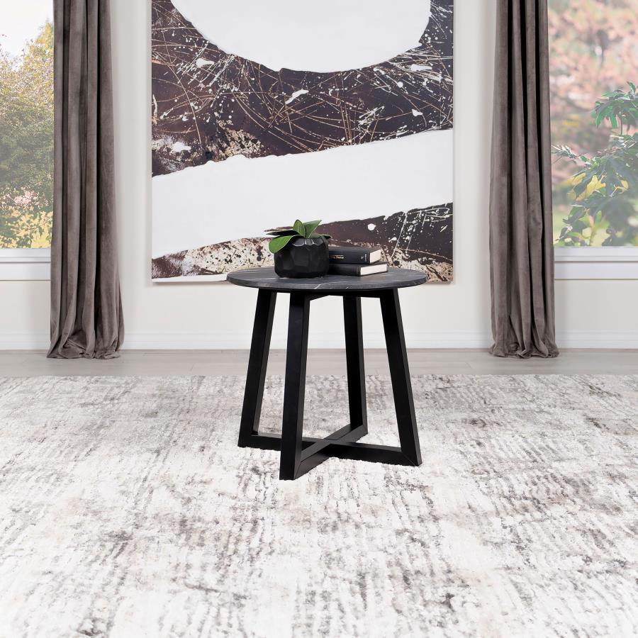 Gracefully poised, the round end table is a modern muse clad in black faux marble, a high-pressure laminate that promises enduring strength and effortless care. This exquisite tabletop, impervious to the whims of daily life, offers the opulent look of mar