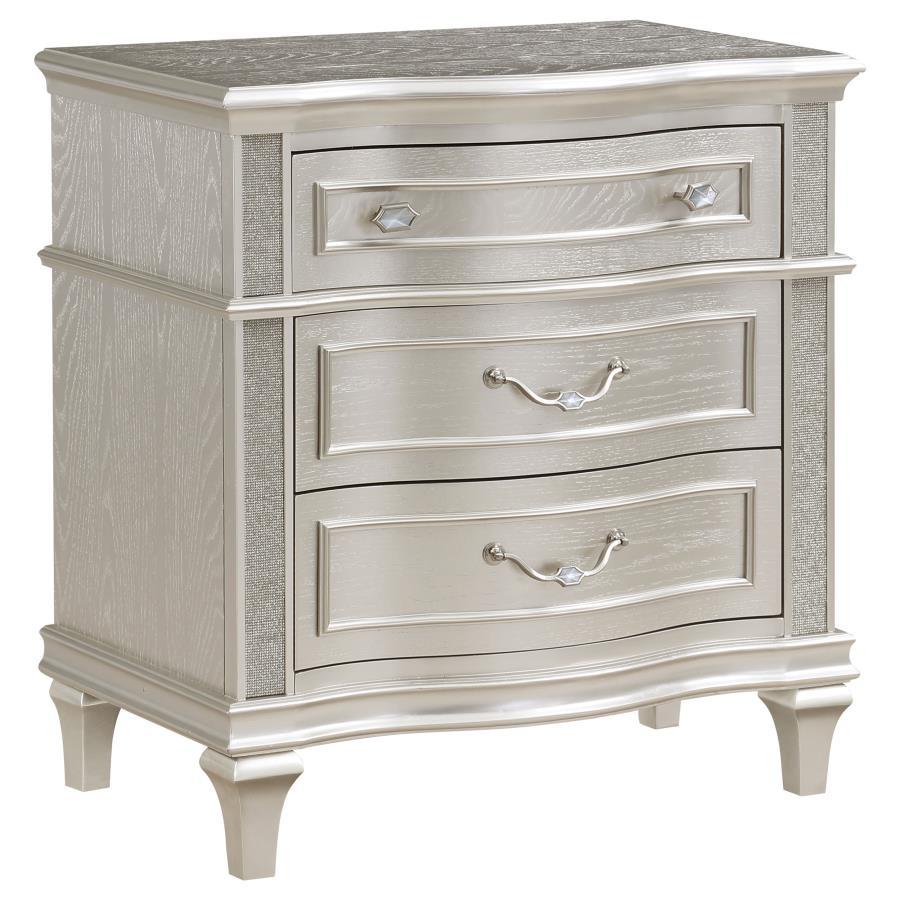 Keep all your bedroom essentials and wardrobe items neatly organized with this glam three-drawer nightstand. A contoured frame design features sparkling side panels flanking the three spacious drawers for a luxurious touch. A silver oak finished wood fram