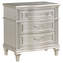 Keep all your bedroom essentials and wardrobe items neatly organized with this glam three-drawer nightstand. A contoured frame design features sparkling side panels flanking the three spacious drawers for a luxurious touch. A silver oak finished wood fram