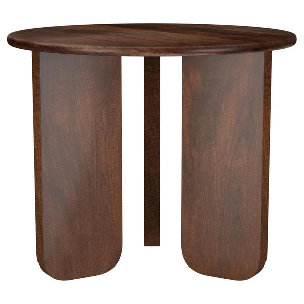 Instill an organic sense of artistry in your living space with this beautifully crafted end table. Made from solid mango wood, it features a deep brown finish that highlights the natural wood grain for added character. The round tabletop provides a stylis