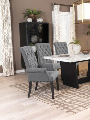  this arm chair brings an elegant presence to any dining space. Its button-tufted high back and rolled top lend a timeless aesthetic