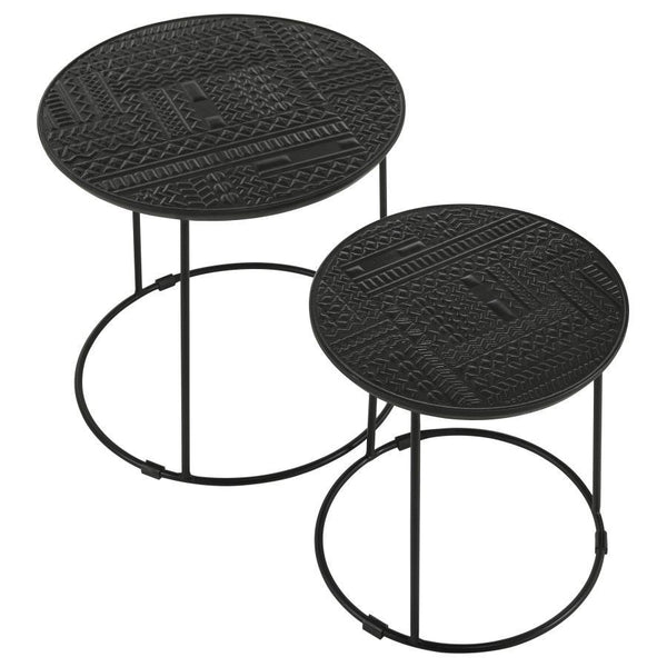  the embossed tribal-inspired ink blot pattern on the round tabletops adds a textured global aesthet