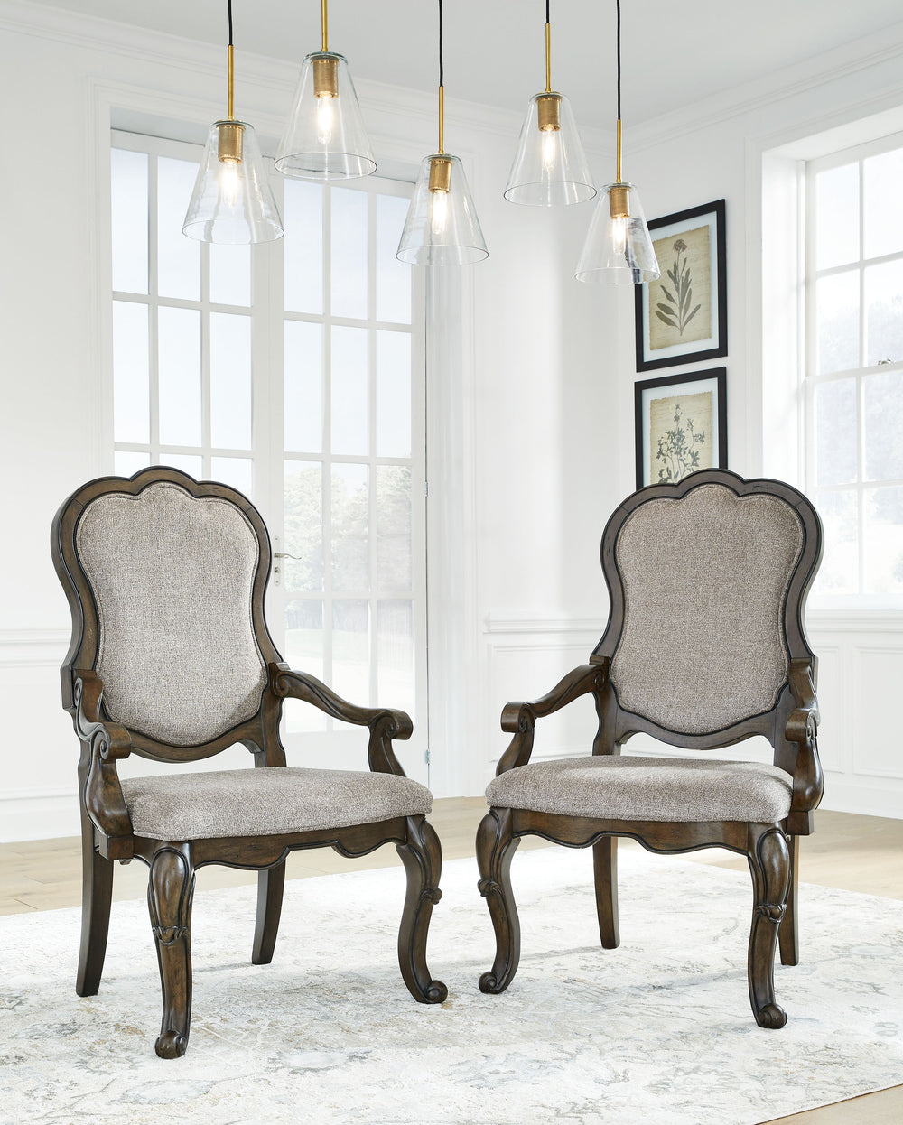 From the ornamental appliques to the large scale, this dining armchair makes a bold statement. With shapely legs and a plush cushioned seat and back, the opulent piece wows with stunning style. The look is timeless. The feel? Right at home.<br><br><b>Addi