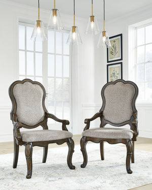 From the ornamental appliques to the large scale, this dining armchair makes a bold statement. With shapely legs and a plush cushioned seat and back, the opulent piece wows with stunning style. The look is timeless. The feel? Right at home.<br><br><b>Addi