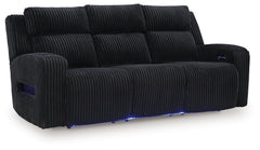 Trend-right style, meet irresistible modern function. Your living room gets a cozy-cool upgrade with this power reclining sofa. Curl up in its ultra-chic corded upholstery and recline with one-touch controls. Is it movie night or game time? With ambient L