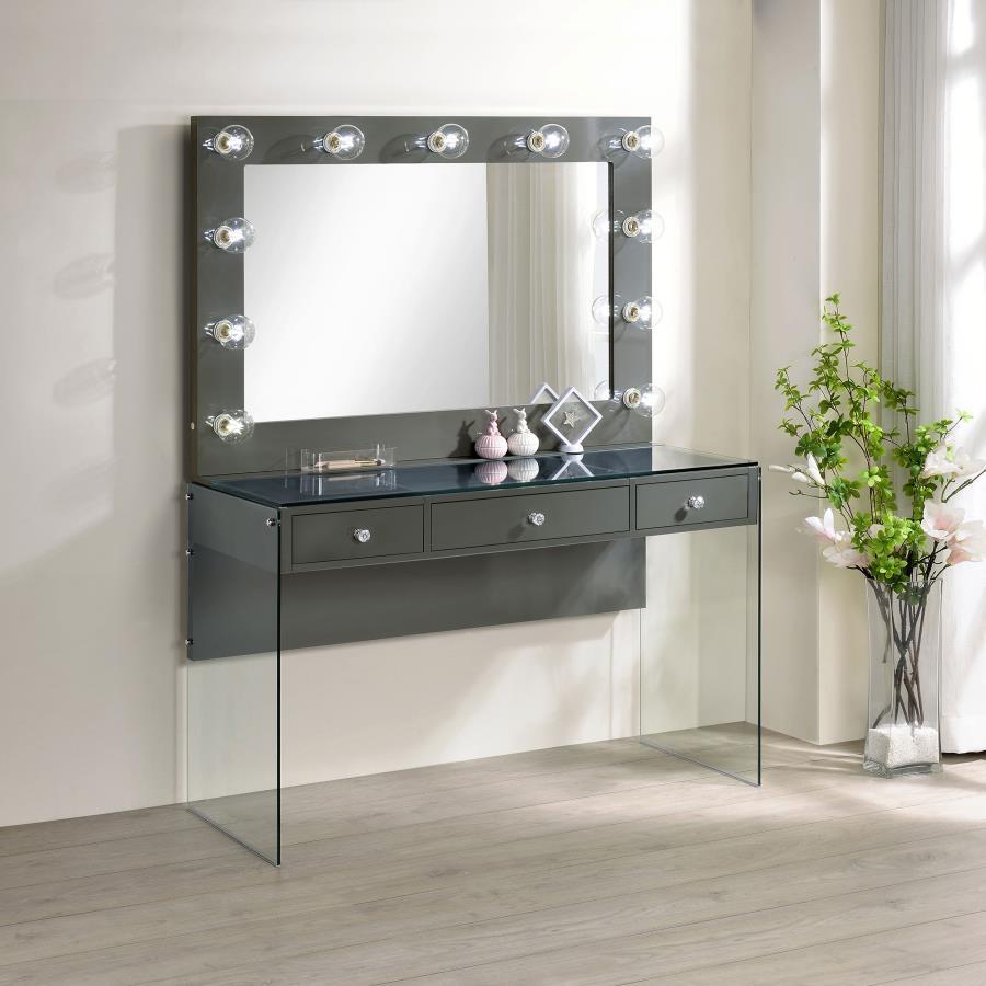Add a bold, dramatic touch with this modern vanity set. Complete with a smooth, grey high gloss lacquer finish across the tabletop and mirror frame, this vanity matches a variety of color palettes. Supported by clear tempered glass side panels, the vanity