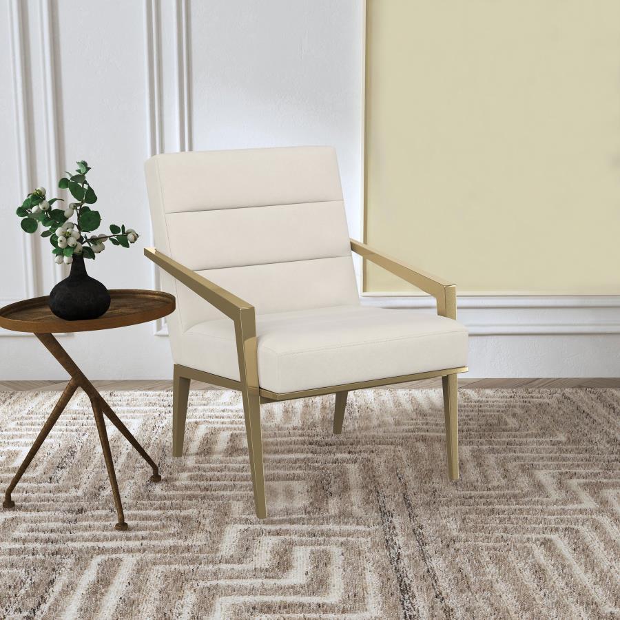 Restrained, modern style meets elegant artistry in a striking contemporary armchair. Designed to stand out, it boasts an upholstered seat and back with a metal frame and arms. The streamlined look receives a gleaming gold finish, adding sophistication any