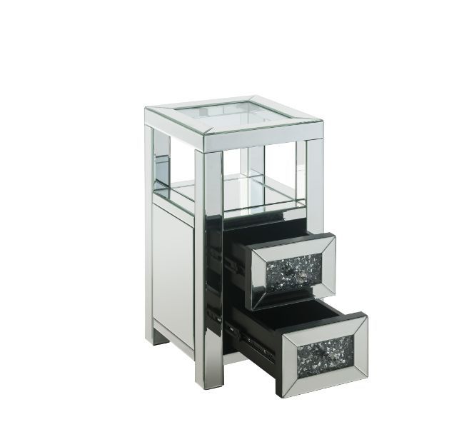 The modern glamour of the Noralie Accent Table will brighten your foyer or bedroom. This brilliant accent table features a mirrored finish and a clear tempered glass top, adding dimension, contrast, and shine to this functional piece. It has two drawers w