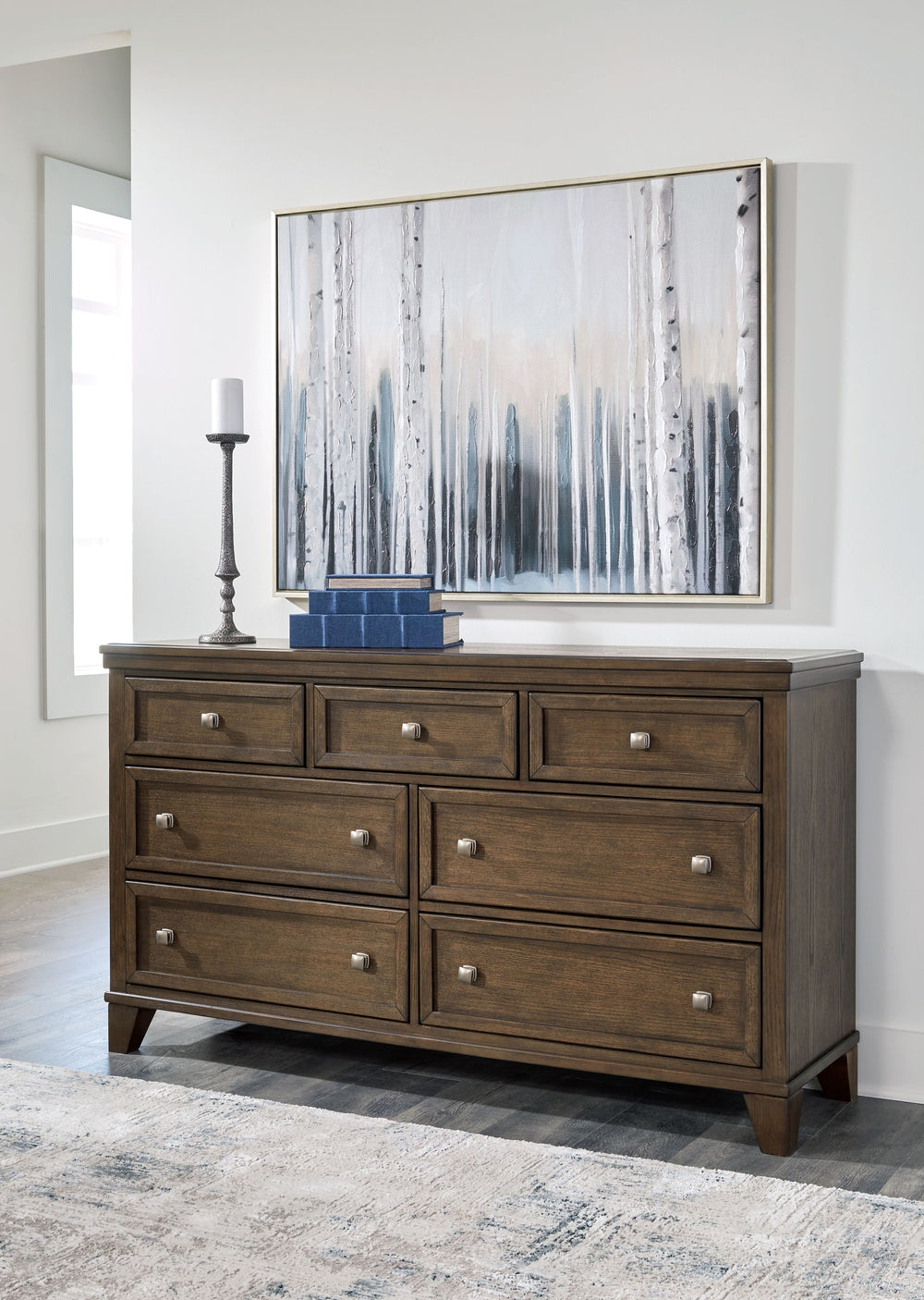 This dresser is well-suited to everyday living with its expertly balanced approach to style and function. Take the stress out of decoratingâ€”a classic medium brown finish easily pairs with existing furniture pieces. And its timeless design stays in style