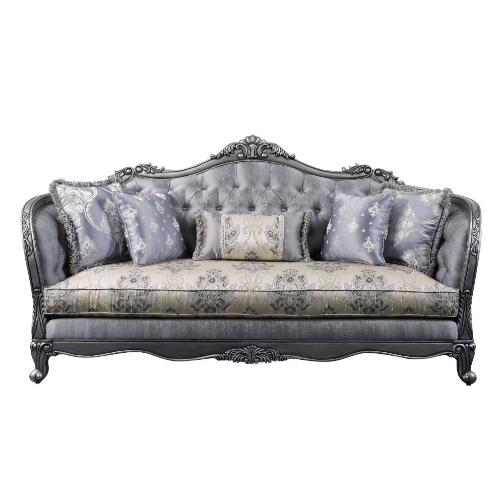 The Ariadne sofa collection is fit for royalty! The platinum finish of the wooden frame complements the lustrous upholstery over button-tufted seatback and inner armrests. Carved flourishes crown the arched seatbacks and extend down the molding around the