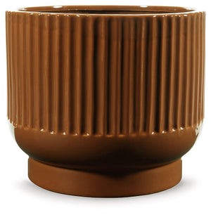 This ceramic vase makes a relaxed style statement. Its casual design and earthy burnt umber glaze complement your laid-back sensibilities. Delightfully simple and simply delightful, this vase subtly wows on its own or when filled with your favorite flower