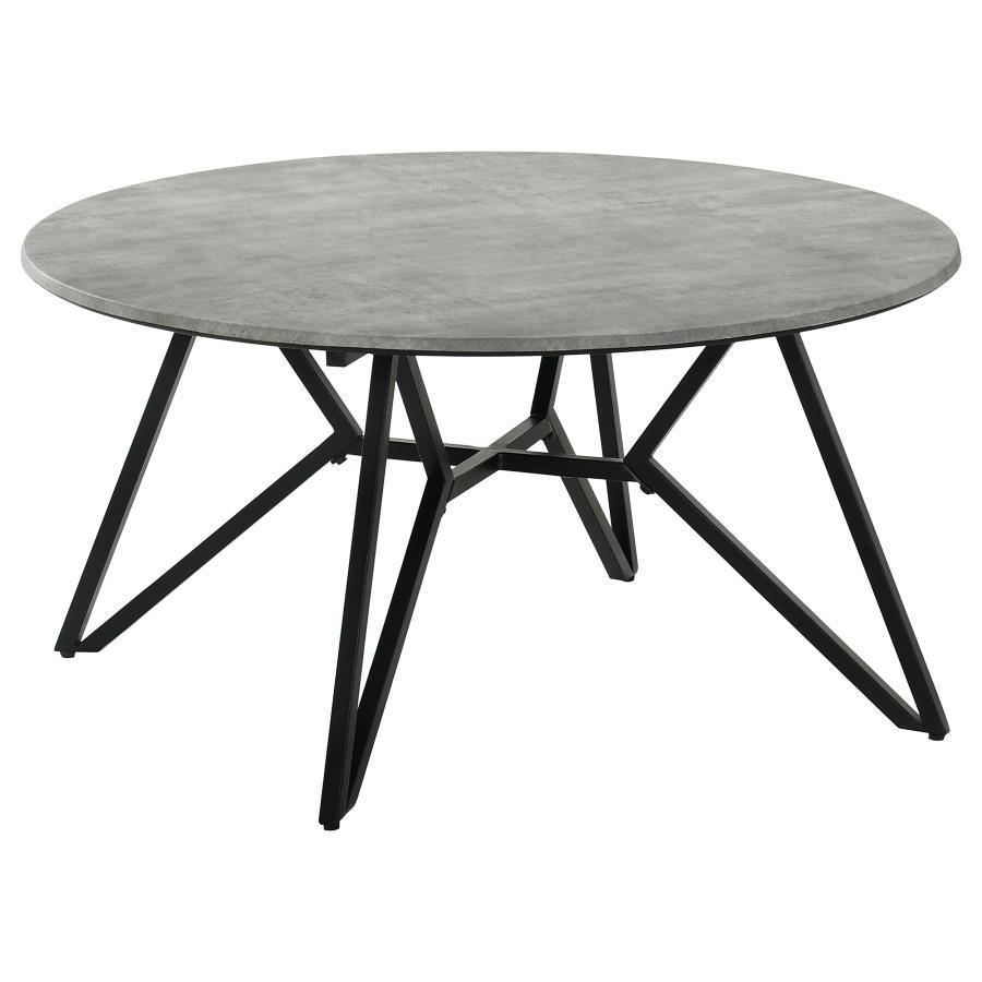 Gunmetal finish hairpin legs offer an industrial edginess to this modern coffee table. Designed with a faux cement top in an elegant round shape, this spacious cocktail table offers a casual, chic space to keep books, cocktails and more. The cement-like t