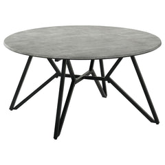 Gunmetal finish hairpin legs offer an industrial edginess to this modern coffee table. Designed with a faux cement top in an elegant round shape, this spacious cocktail table offers a casual, chic space to keep books, cocktails and more. The cement-like t