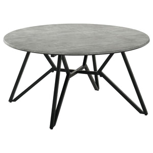 Gunmetal finish hairpin legs offer an industrial edginess to this modern coffee table. Designed with a faux cement top in an elegant round shape, this spacious cocktail table offers a casual, chic space to keep books, cocktails and more. The cement-like t