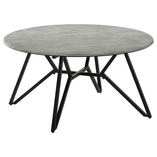 Gunmetal finish hairpin legs offer an industrial edginess to this modern coffee table. Designed with a faux cement top in an elegant round shape, this spacious cocktail table offers a casual, chic space to keep books, cocktails and more. The cement-like t
