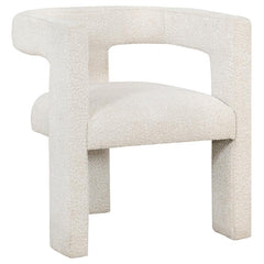 Enveloped entirely in the embrace of plush bouclÃ©, this chair redefines the art of relaxation with its all-fabric design. The seamless transition from the cushioned seat to the curved arms, all robed in the same soft fabric, creates a cocoon of comfort. 
