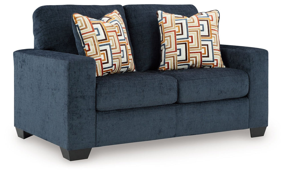 Looking to make a bold statement with color? Liven up your living room with this loveseat. Its trend-right navy blue upholstery adds a playful pop of color to your decor. Bold and eclectic accent pillows complete the look. Pairing posh style with everyday
