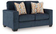 Looking to make a bold statement with color? Liven up your living room with this loveseat. Its trend-right navy blue upholstery adds a playful pop of color to your decor. Bold and eclectic accent pillows complete the look. Pairing posh style with everyday