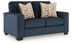 Looking to make a bold statement with color? Liven up your living room with this loveseat. Its trend-right navy blue upholstery adds a playful pop of color to your decor. Bold and eclectic accent pillows complete the look. Pairing posh style with everyday