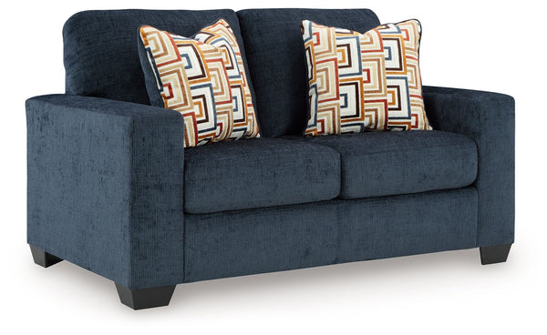 Looking to make a bold statement with color? Liven up your living room with this loveseat. Its trend-right navy blue upholstery adds a playful pop of color to your decor. Bold and eclectic accent pillows complete the look. Pairing posh style with everyday