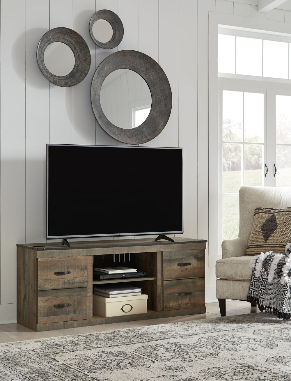 Entertain a rugged yet refined sense of style with this TV stand. Rustic finish and plank-style details pay homage to reclaimed barn wood, while faux metal banding with nailhead accents infuses a touch of industrial cool. Ultra clean lines ensure a look t
