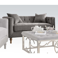 Sidonia collection is a distinct piece that intersects the mid-century and today. Expertly handcrafted in selected velvet fabric, features tufted back cushion, bench style seating, high shelter armrest with nailhead trim and wooden turned leg. Complemente