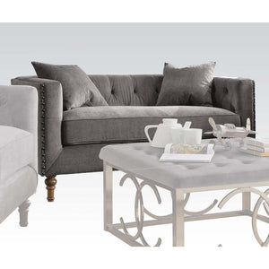 Sidonia collection is a distinct piece that intersects the mid-century and today. Expertly handcrafted in selected velvet fabric, features tufted back cushion, bench style seating, high shelter armrest with nailhead trim and wooden turned leg. Complemente
