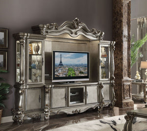 The Versailles the entertainment center was inspired by old European design. This collection features carved scrollwork accent on the bridge-'s crown. The collection pieces are carefully crafted with selected wood and veneers in antique platinum finish wi