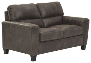 If you love the cool look of leather but long for the warm feel of fabric, you can take comfort in this loveseat. Wrapped in a fabulous faux leather with a weathered hue and hint of pebbly texture to resemble the real deal, this decidedly modern loveseat 