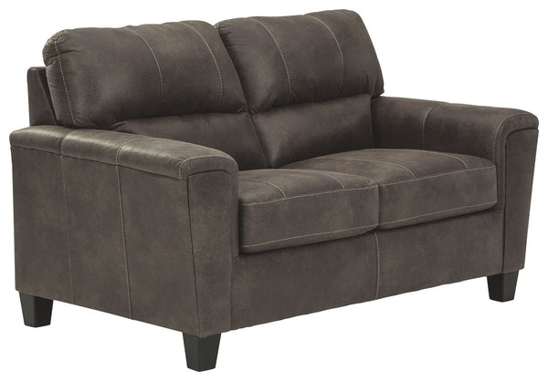 If you love the cool look of leather but long for the warm feel of fabric, you can take comfort in this loveseat. Wrapped in a fabulous faux leather with a weathered hue and hint of pebbly texture to resemble the real deal, this decidedly modern loveseat 