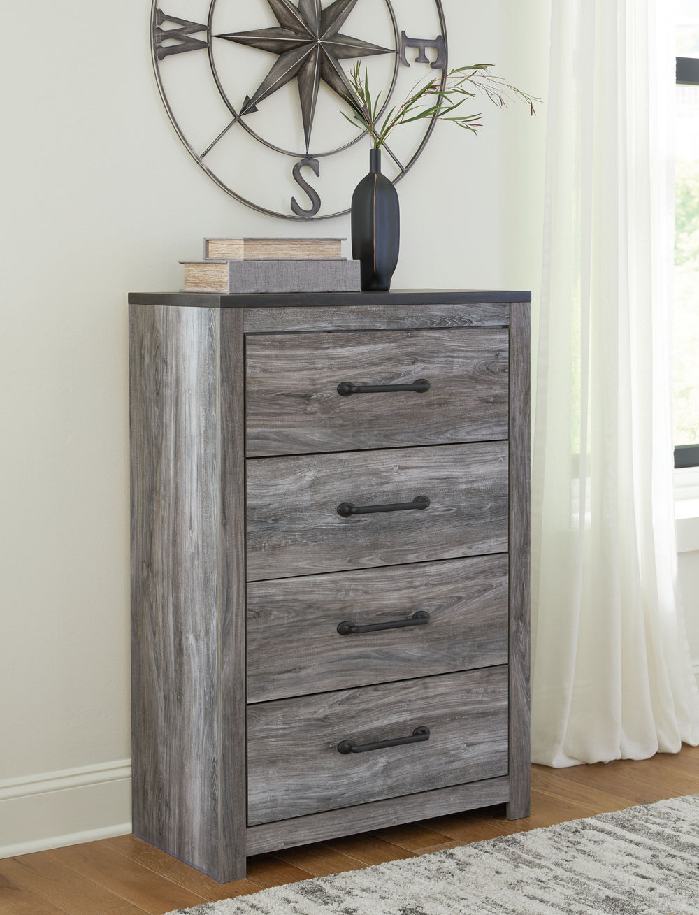 Alluring smoky gray hues create an ambiance that just feels right. This 4-drawer chest has a charming wood-like appeal enriched by a two-tone, textured look. Light neutral shades contrasted by a dark charcoal finish bring a refined yet relaxed feel to con