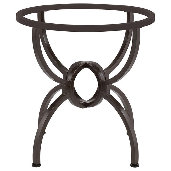 the table boasts a round of clear glass resting on a bold base. The base shows off metal construction with four stylized M legs that meet in an interlo