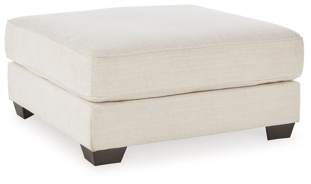Delightfully modern. Exceptionally comfortable. If casually cool elegance is the look you-'re going for, this ottoman pleases in striking style. A plush top invites you to kick back and stay a while. Elevated in design, this companion piece is sure to be 