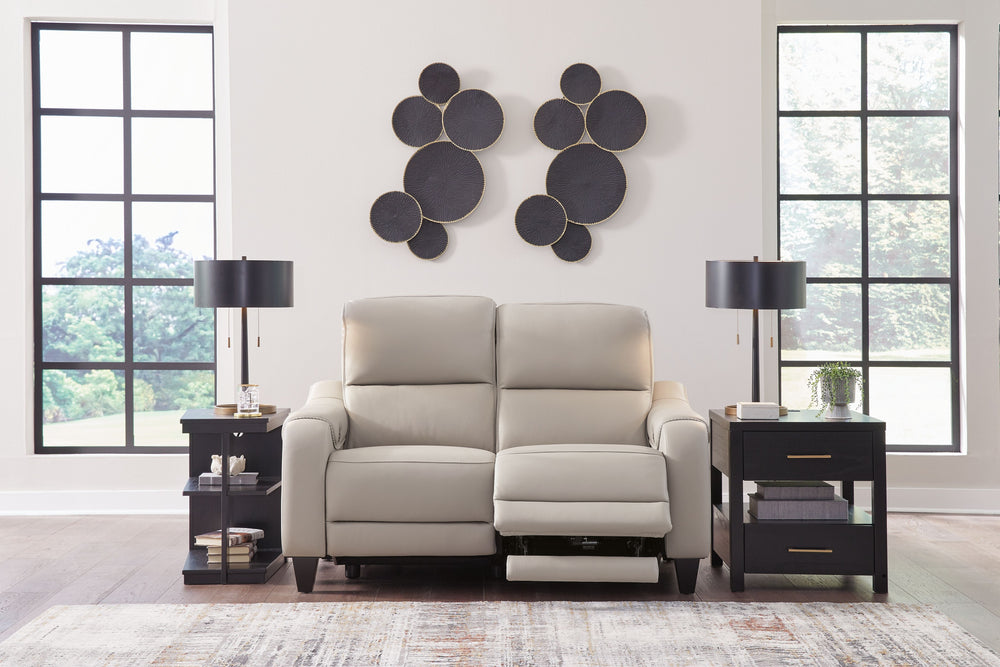 This power reclining loveseat puts a sleek twist on laid-back living. It satisfies your desire for comfort without being bulky in design, thanks to subtly incorporated one-touch reclining and adjustable headrests. With chic exposed legs and stunning stitc