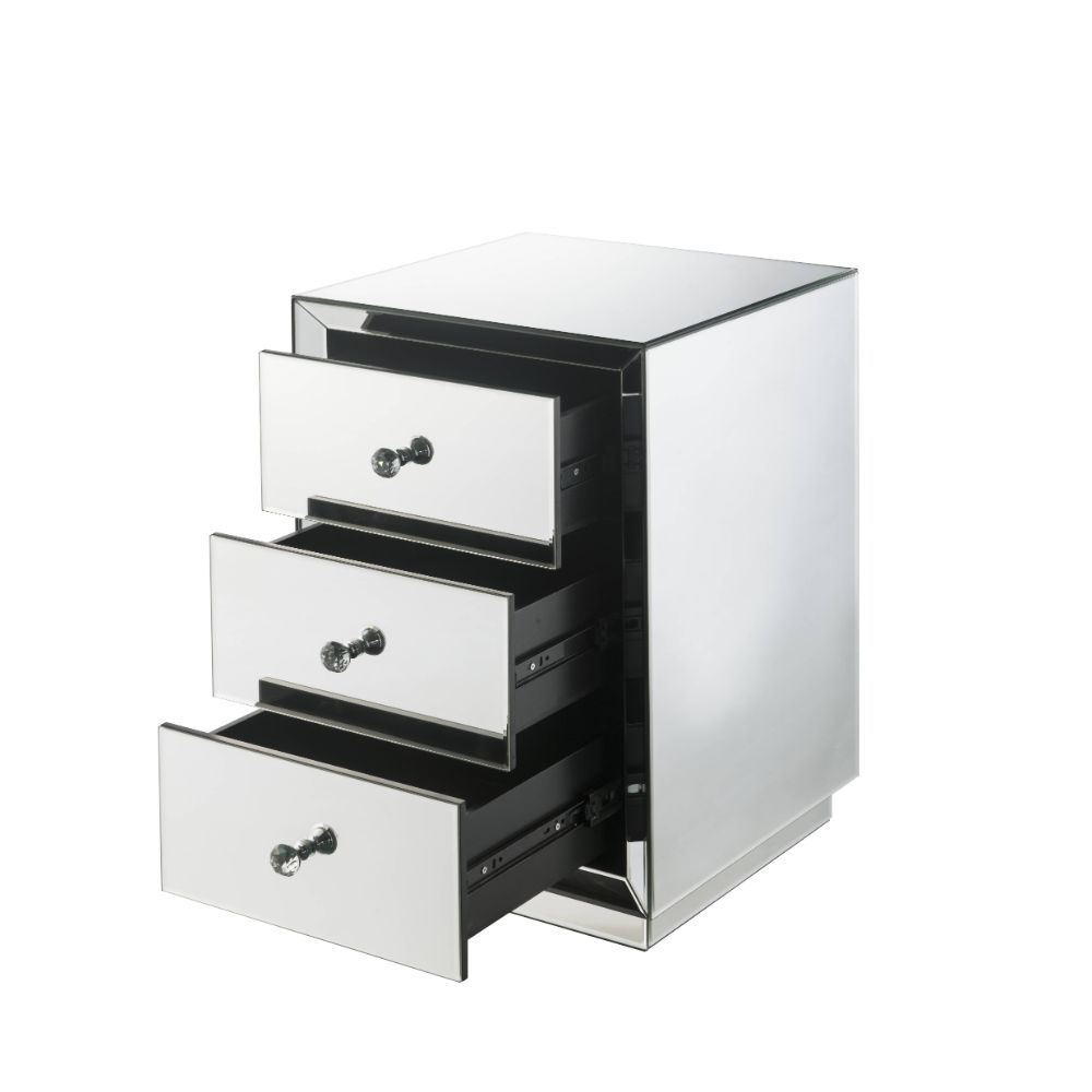 The Nyoka occasional table is perfect for your modern grace bedside. This dazzling table features a sturdy wood frame fully lined in beveled mirrors that will reflect light and your bold beauty. Its three drawers boast crystal knobs and are right size for