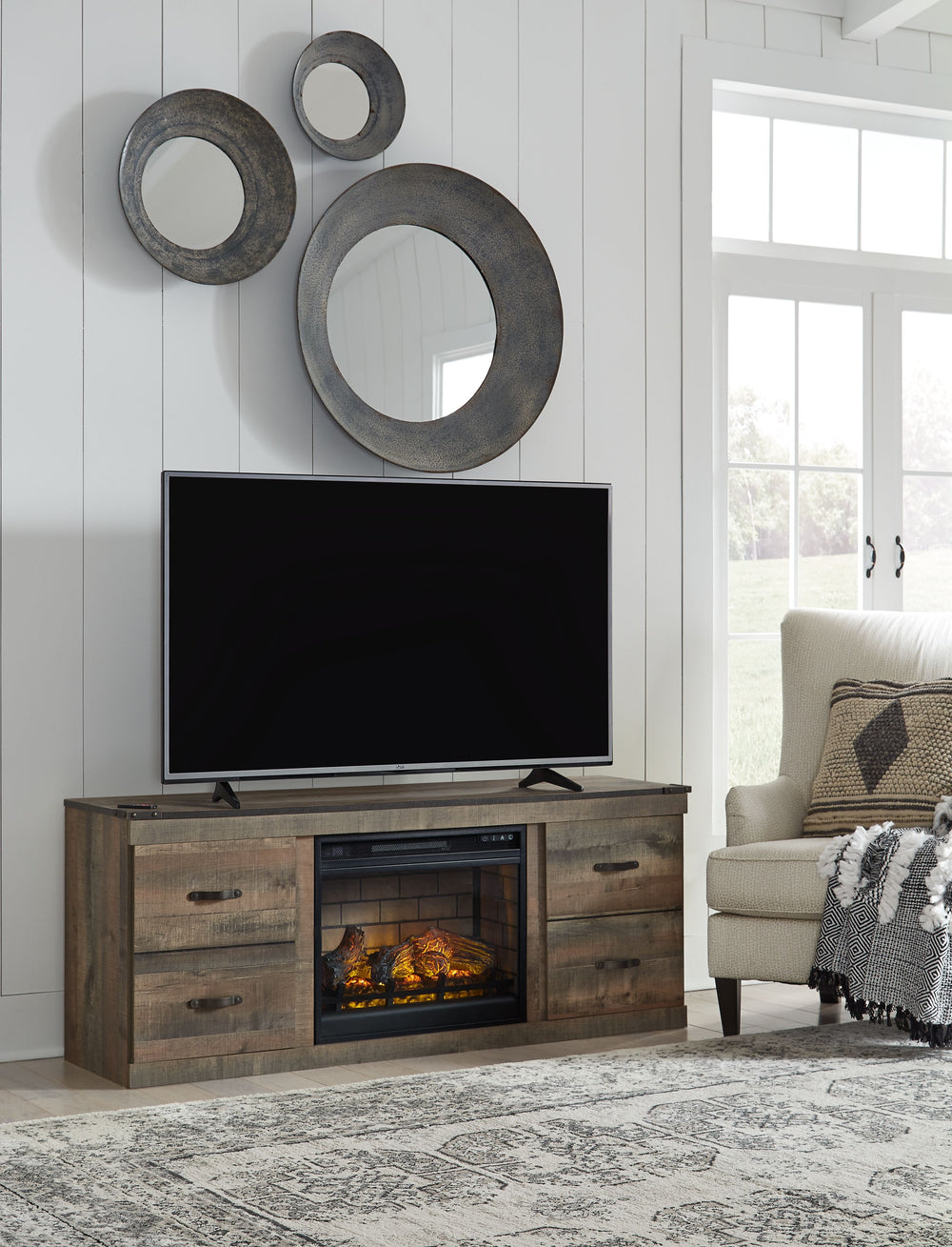 Entertain a rugged yet refined sense of style with this TV stand with LED fireplace insert. Its rustic finish and plank-style details pay homage to reclaimed barn wood, while faux metal banding with nailhead accents infuses a touch of industrial cool. Ult