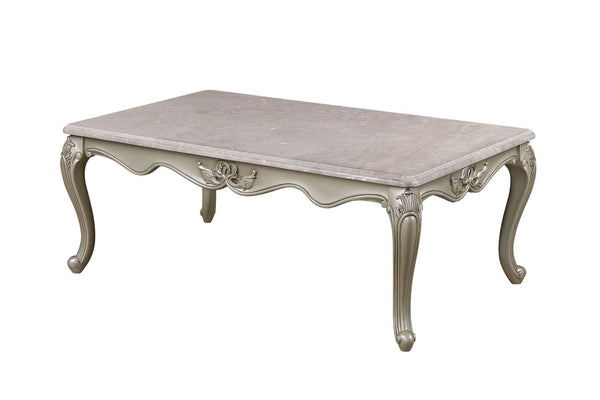 The Monique Royal Classic Cocktail Table in champagne epitomizes heirloom-quality craftsmanship and timeless elegance. Expertly constructed from premium pine solids and adorned with durable polyurethane carvings, this coffee table is lightweight, moisture