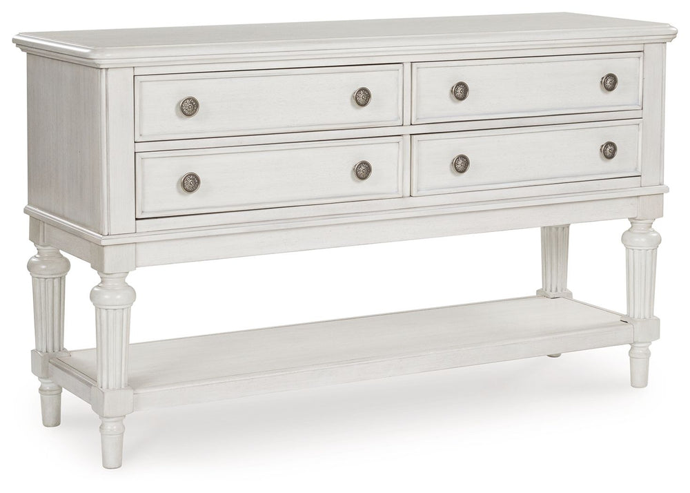 Transform your home into a haven of timeless elegance with this dining server. It pairs a classic antiqued white finish with reeded legs for traditional styling. Four drawers with fully finished interiors offer spacious storage for essentials. The large s