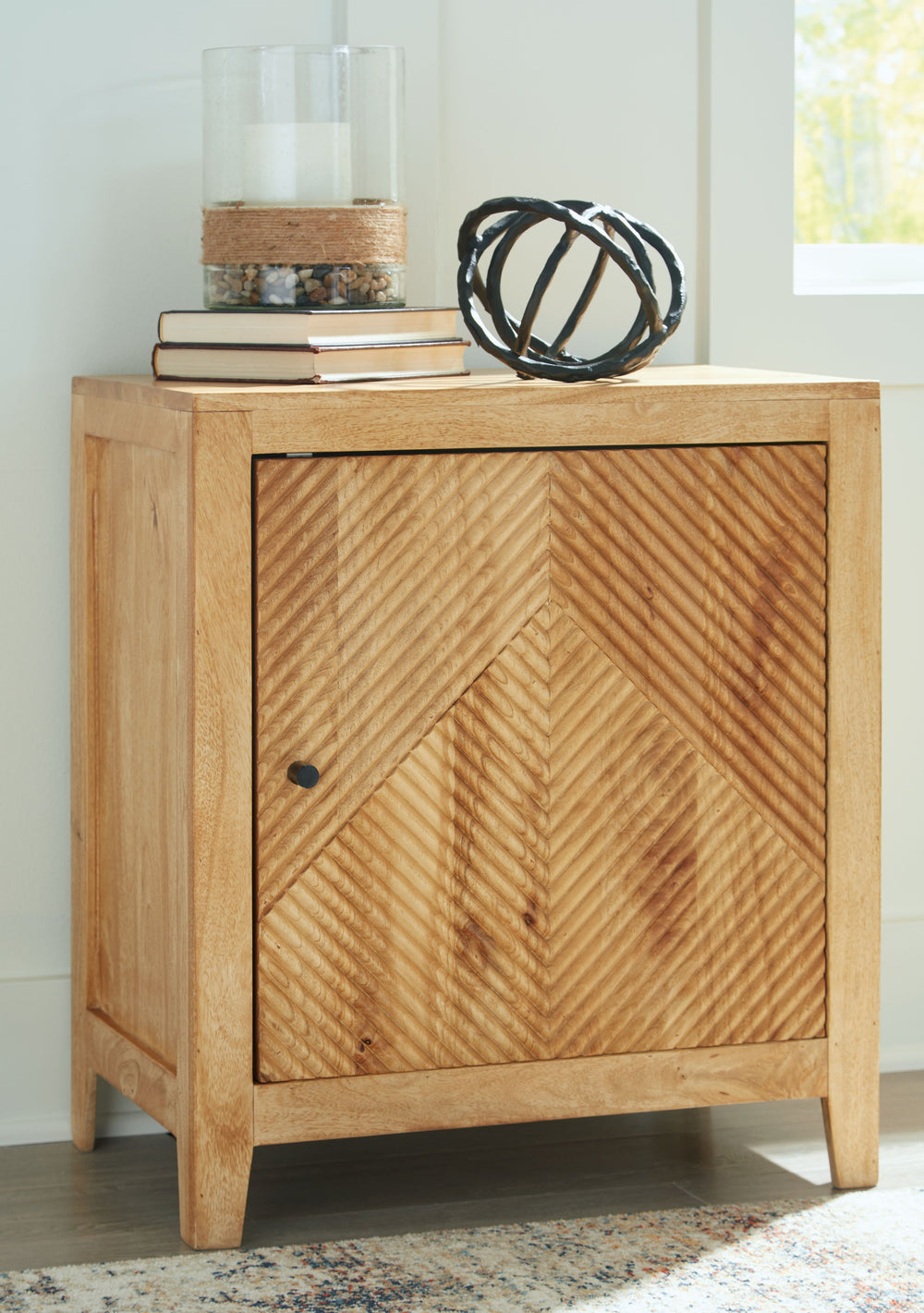 With a variety of uses, this storage cabinet caters to your need for fashionable function. Searching for a spot to tuck away remotes and controllers? Keep essentials in reach when stored behind the fluted door front. This versatile cabinet can also act as