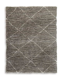 When is a rug more than a rug? When it invites you to kick off your shoes and stay a while. This shag rug welcomes visitors with warmth and a tantalizingly thick, plush pile. Its neutral color palette exudes a casually cool vibe that works wonders whereve