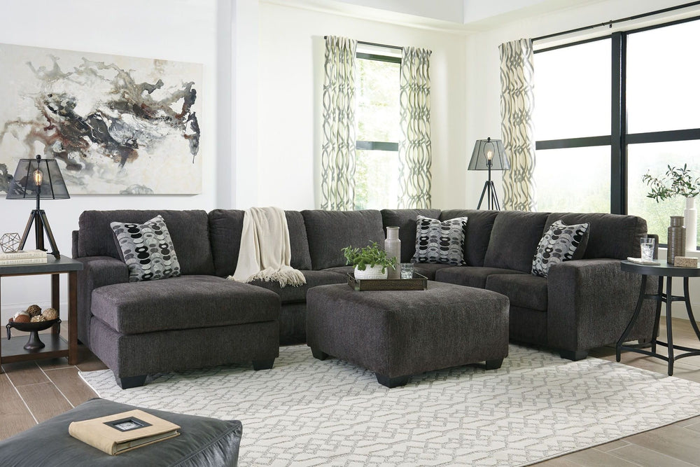 A mastery in less is more, this living room set manages to make cool, contemporary design so warm and cozy. A new twist on neutral, the sectionalâ€™s soothing â€œsmokyâ€ gray tone upholstery is incredibly plush to the touch. Gently rounded corners give t
