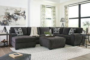 A mastery in less is more, this living room set manages to make cool, contemporary design so warm and cozy. A new twist on neutral, the sectionalâ€™s soothing â€œsmokyâ€ gray tone upholstery is incredibly plush to the touch. Gently rounded corners give t