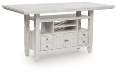 This counter height dining table brings an air of casual charm to mealtime. With its antiqued white finish, farmhouse-style dining has never been so fashionable. And this curated approach to everyday function is loaded with storage options, from cabinets 