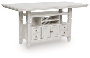 This counter height dining table brings an air of casual charm to mealtime. With its antiqued white finish, farmhouse-style dining has never been so fashionable. And this curated approach to everyday function is loaded with storage options, from cabinets 