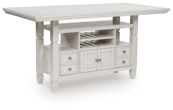 This counter height dining table brings an air of casual charm to mealtime. With its antiqued white finish, farmhouse-style dining has never been so fashionable. And this curated approach to everyday function is loaded with storage options, from cabinets 