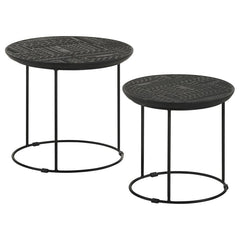 Add a modern rustic touch to your space with this two-piece nesting table set, designed for style and function. Crafted from eco-friendly solid mango wood, the embossed tribal-inspired ink blot pattern on the round tabletops adds a textured global aesthet