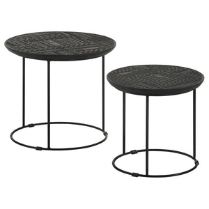 Add a modern rustic touch to your space with this two-piece nesting table set, designed for style and function. Crafted from eco-friendly solid mango wood, the embossed tribal-inspired ink blot pattern on the round tabletops adds a textured global aesthet